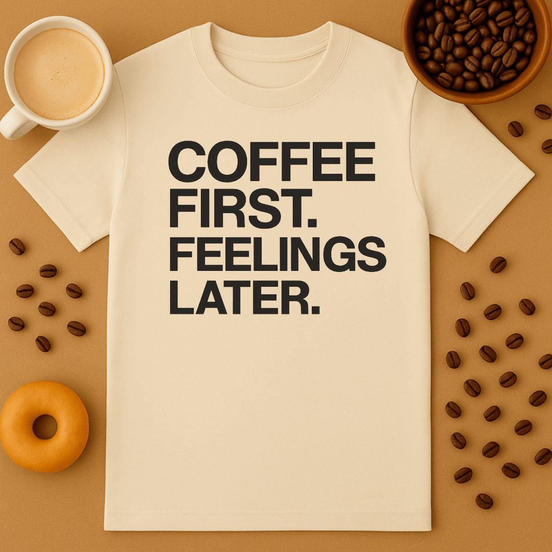 Beige t-shirt with 'Coffee First, Feelings Later' text on a brown background with coffee beans and a cup.