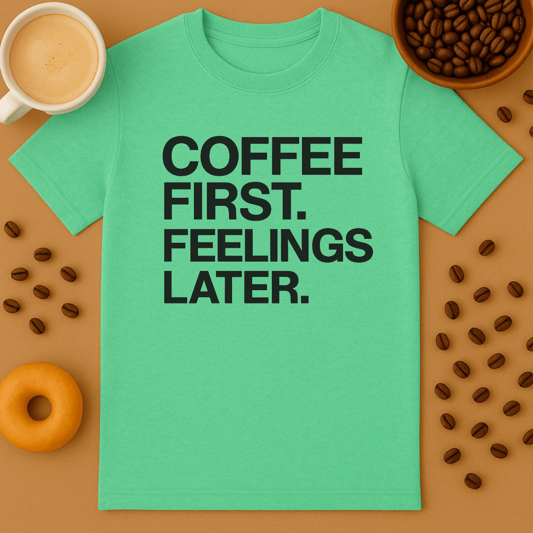 Green t-shirt with 'Coffee First, Feelings Later' text on a brown background with coffee beans and a donut.