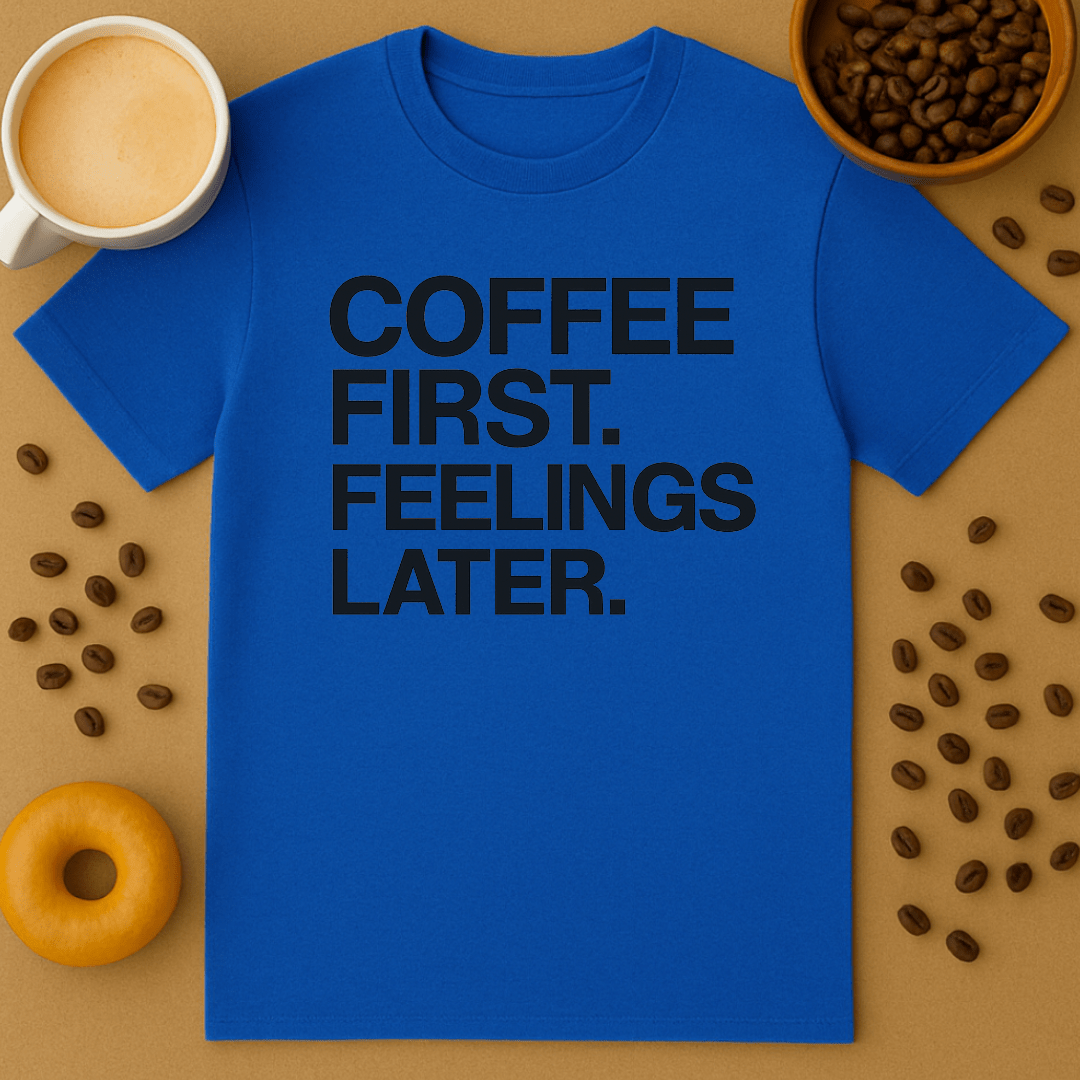 Blue t-shirt with 'Coffee First, Feelings Later' text on a brown background with coffee beans and a donut.